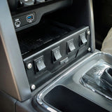 Close-up of a car's control panel with switches and USB ports.