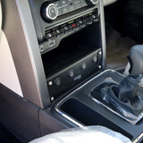 Close-up of a car's center console with gear shift and control panel.